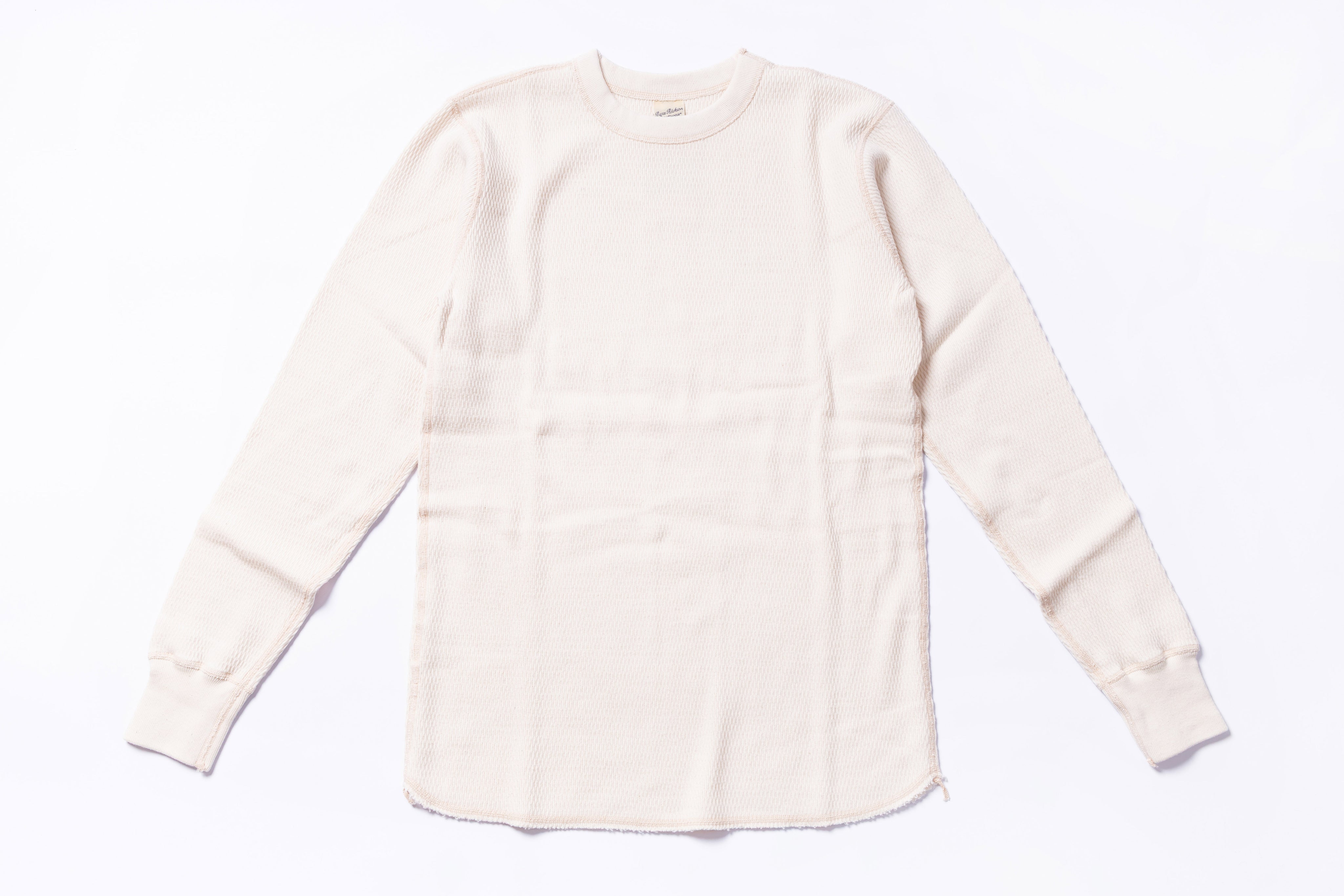 White long-sleeve shirt on a light gray background