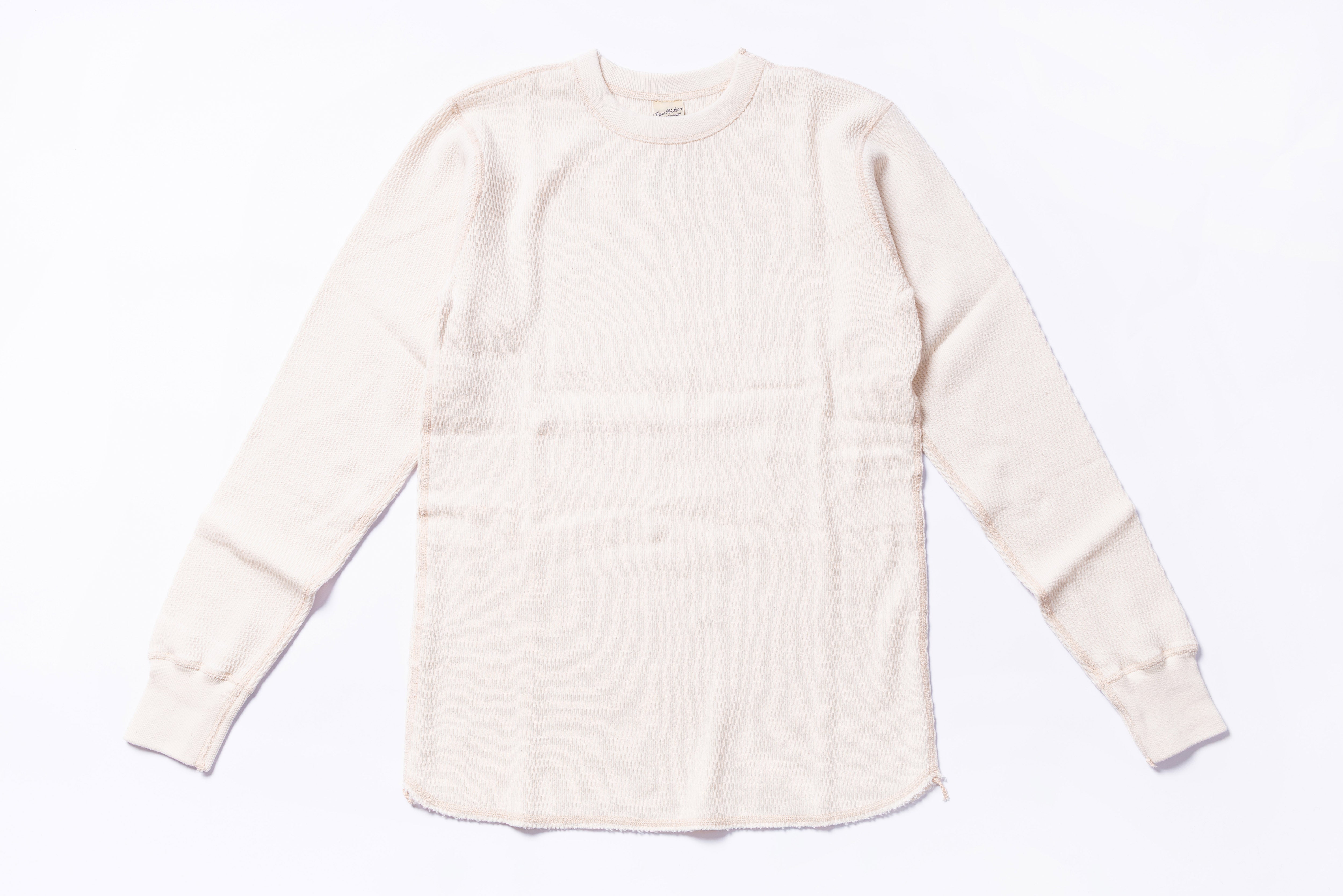 White long-sleeve shirt on a light gray background