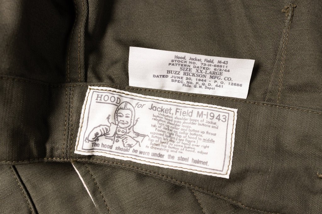 Close-up of a military jacket with labels and text on a dark background