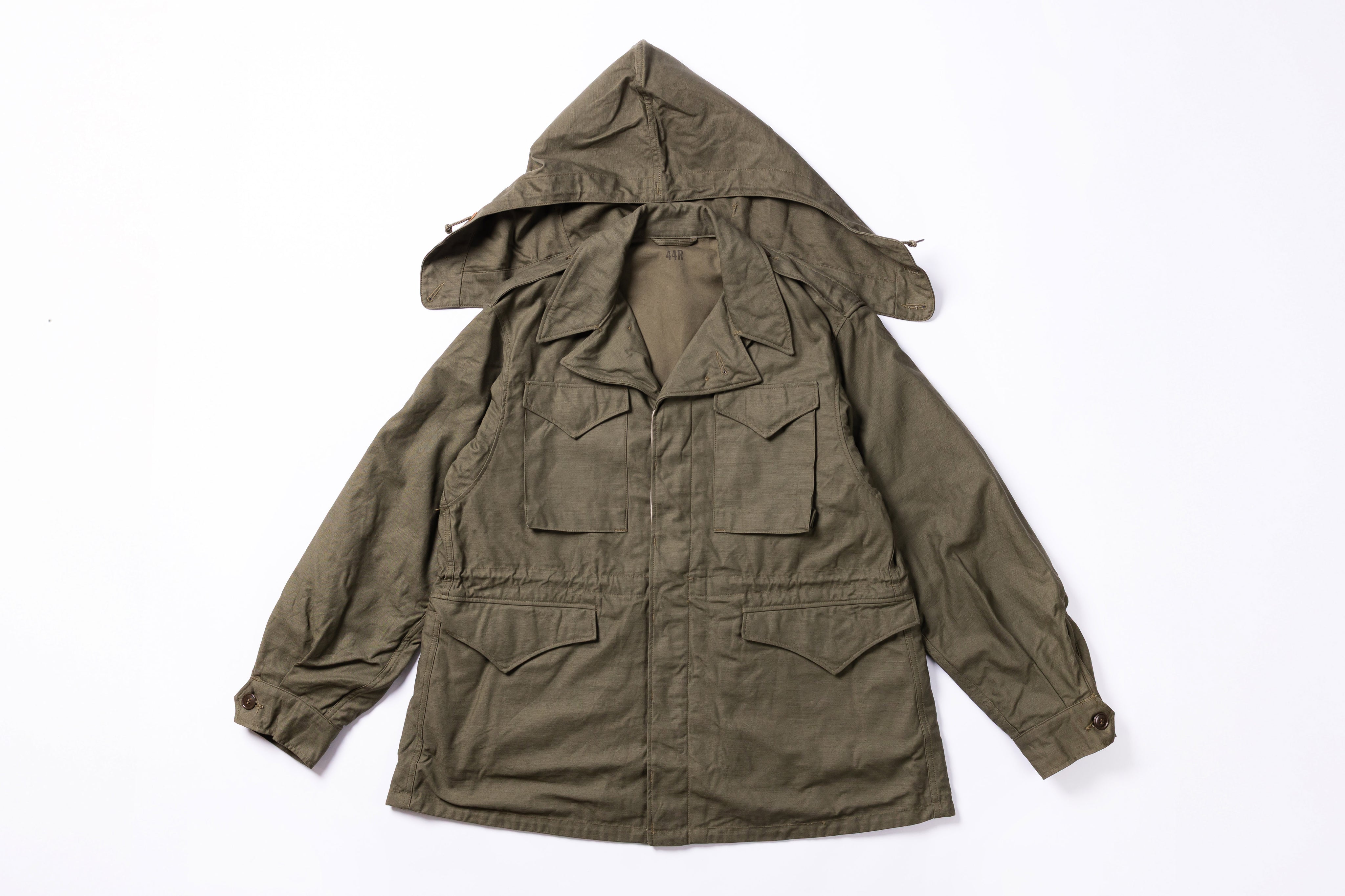 Green hooded jacket on a white background