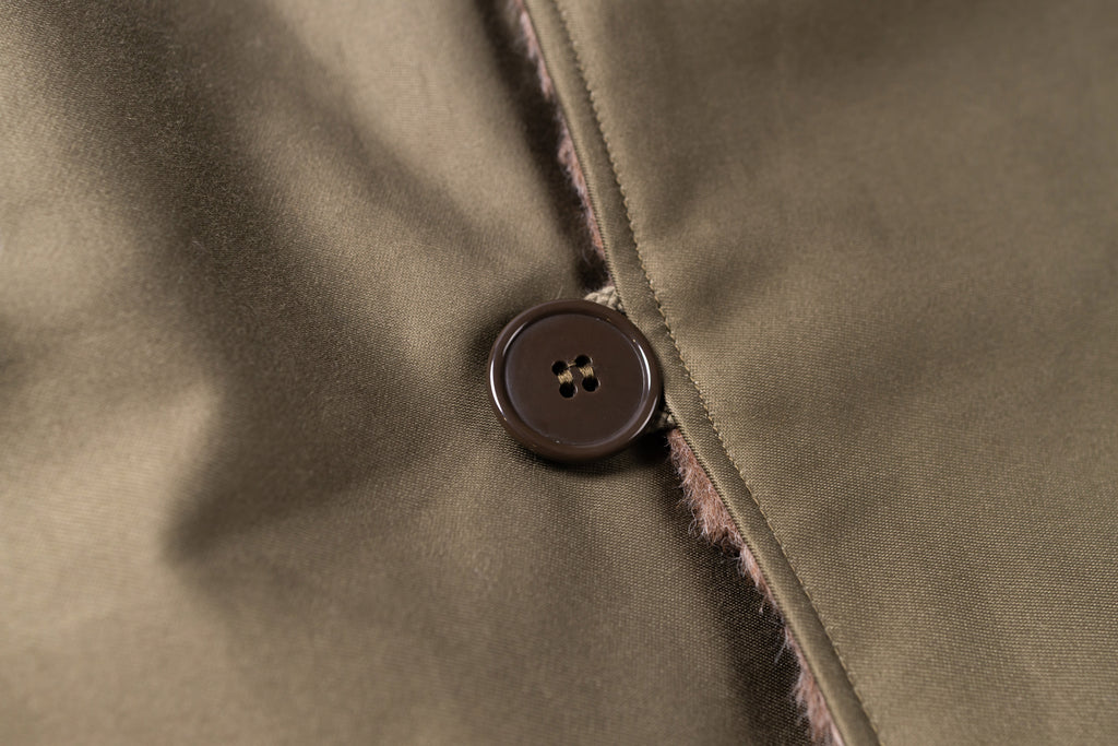 Close-up of a button on a textured fabric surface