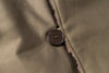 Close-up of a button on a textured fabric surface