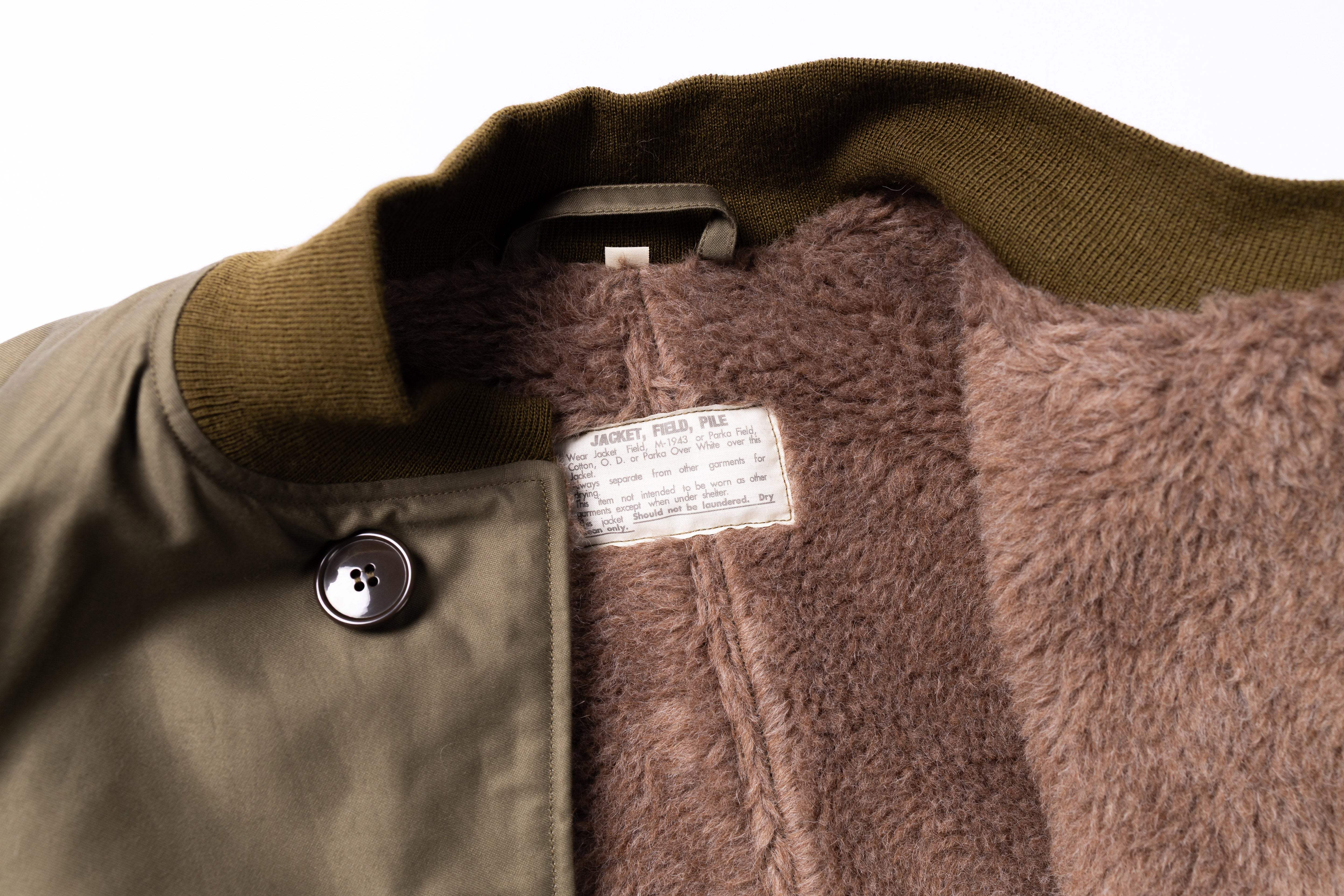 Close-up of a jacket with a label on a white background