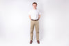 Person wearing a white shirt and beige pants on a white background