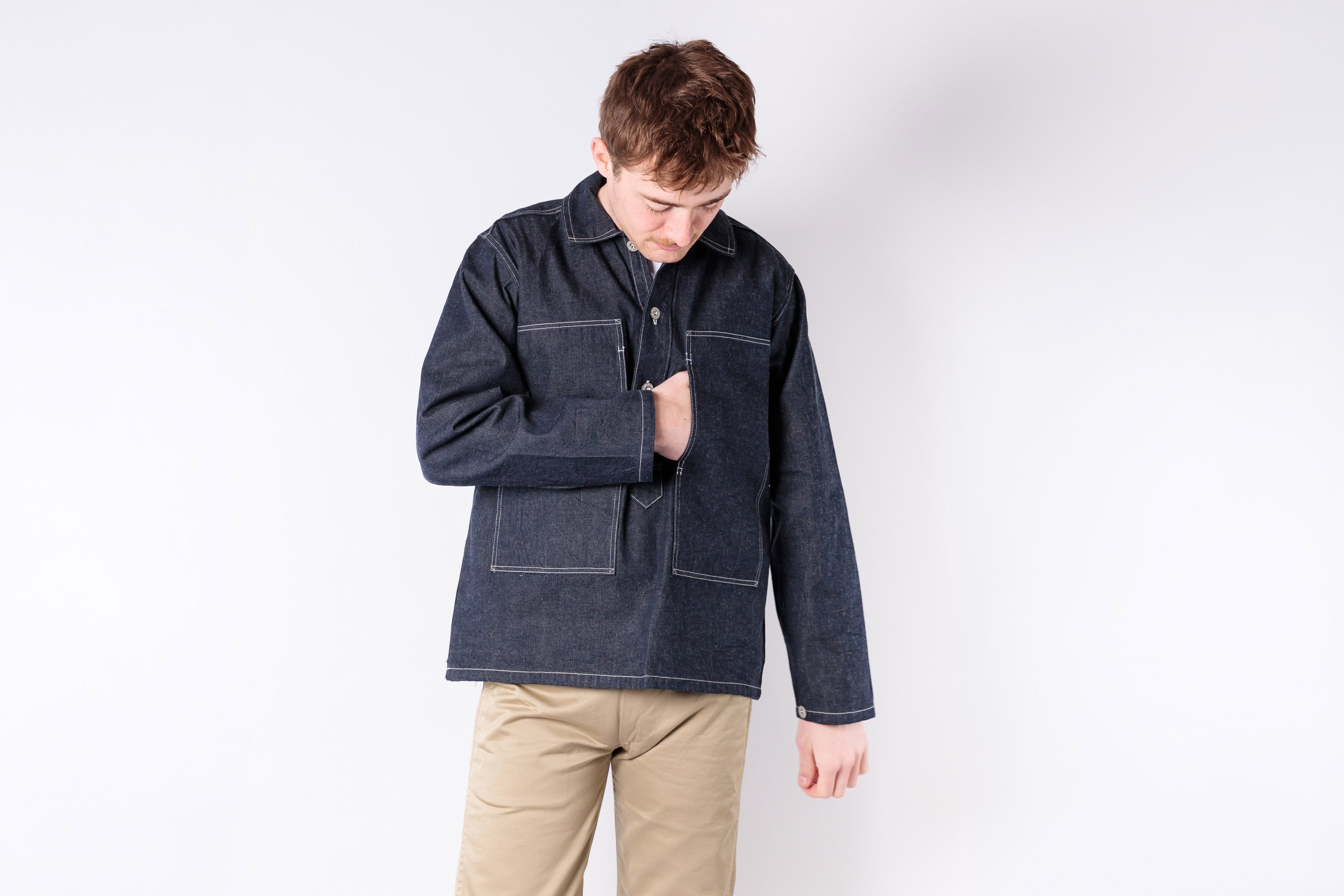 Person wearing a dark blue jacket on a white background