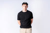 Person wearing a black t-shirt and cap on a white background