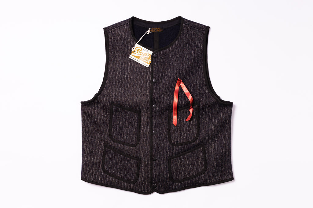 Black vest with a red logo on a white background