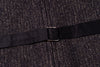 Close-up of a black belt with a buckle on a textured dark fabric background