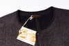 Close-up of a dark textured garment with a Brown's beach jacket brand tag on a white background