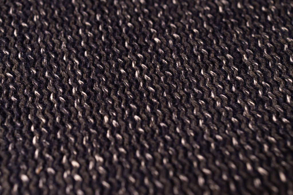 Close-up of a textured brown fabric surface