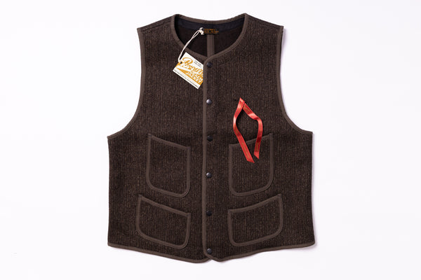 Brown vest with a red emblem on a white background