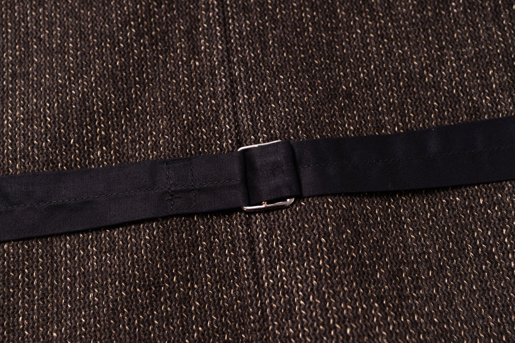 Black belt with a silver buckle on a textured brown background