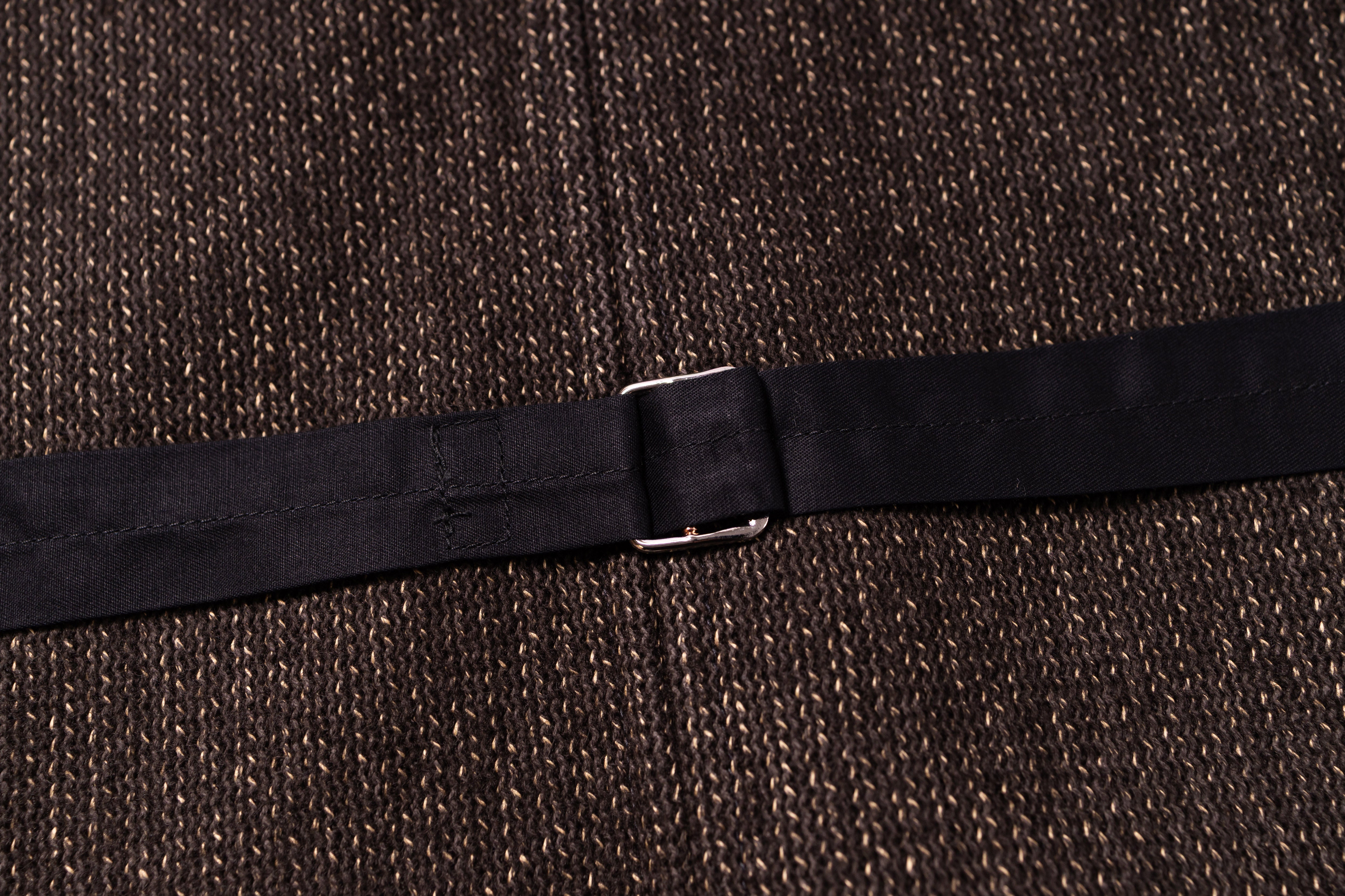 Black belt with a silver buckle on a textured brown background