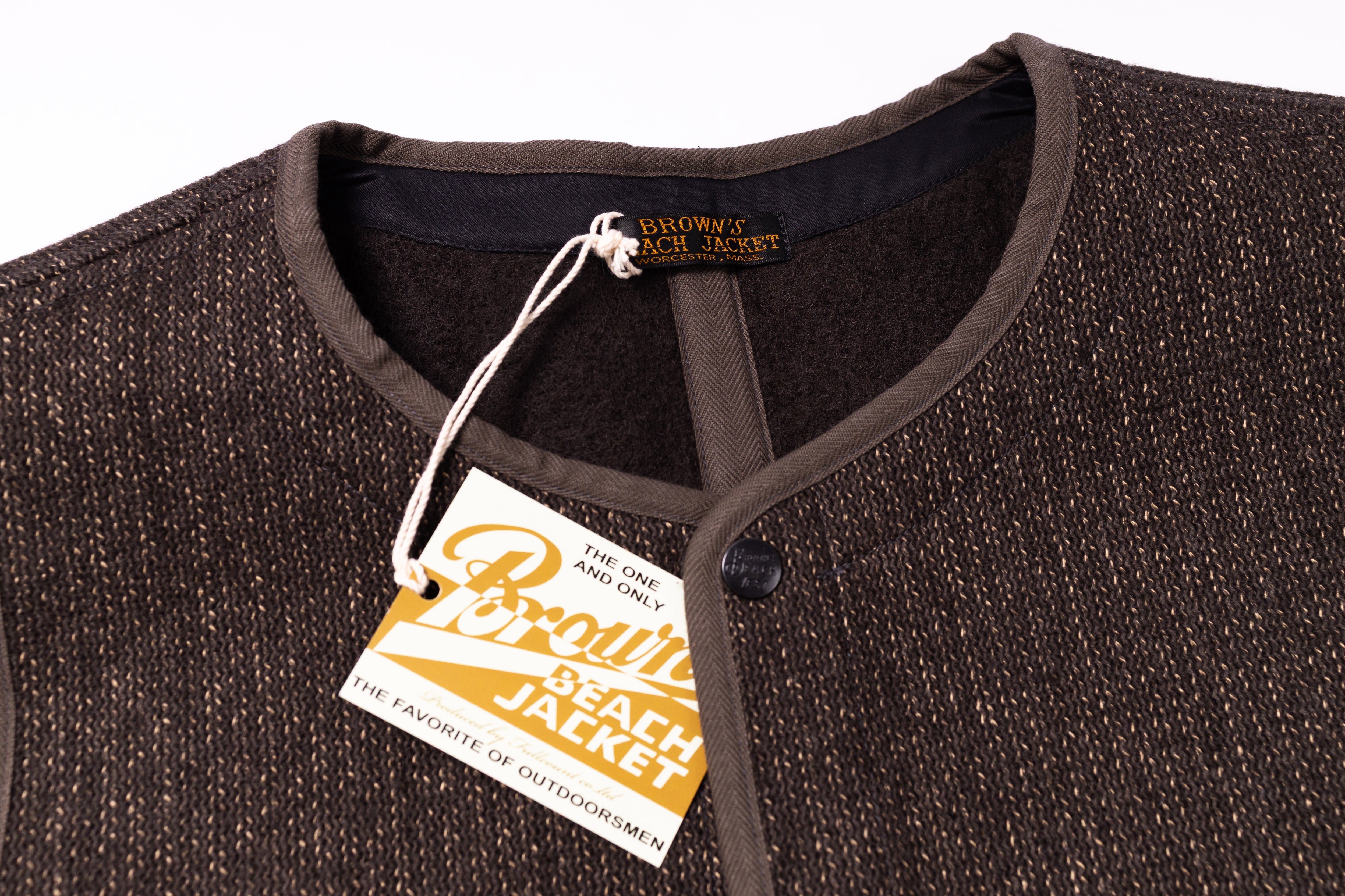 Close-up of a brown jacket with a tag on a white background