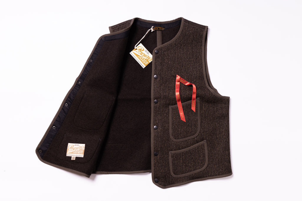 Brown vest with a red ribbon on a white background