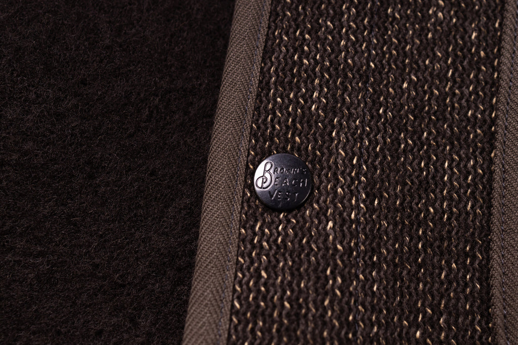Close-up of a textured brown fabric with a button featuring 'Balmorhea' branding.