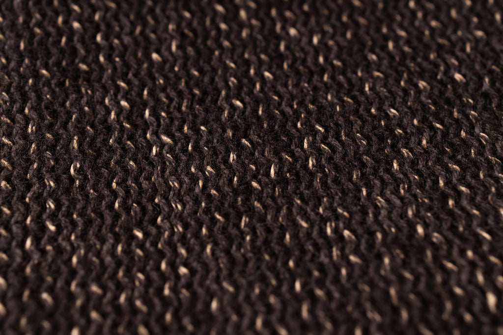Close-up of a textured brown fabric surface