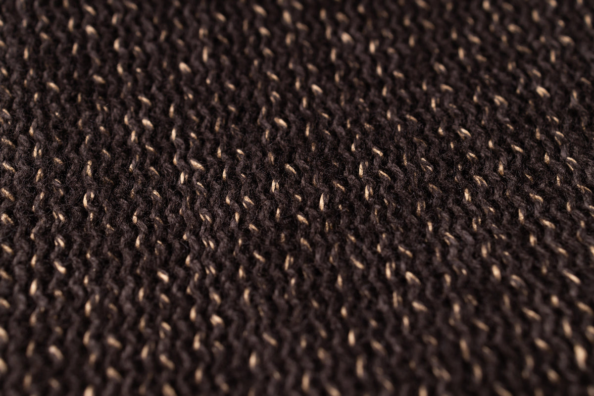Close-up of a textured brown fabric surface