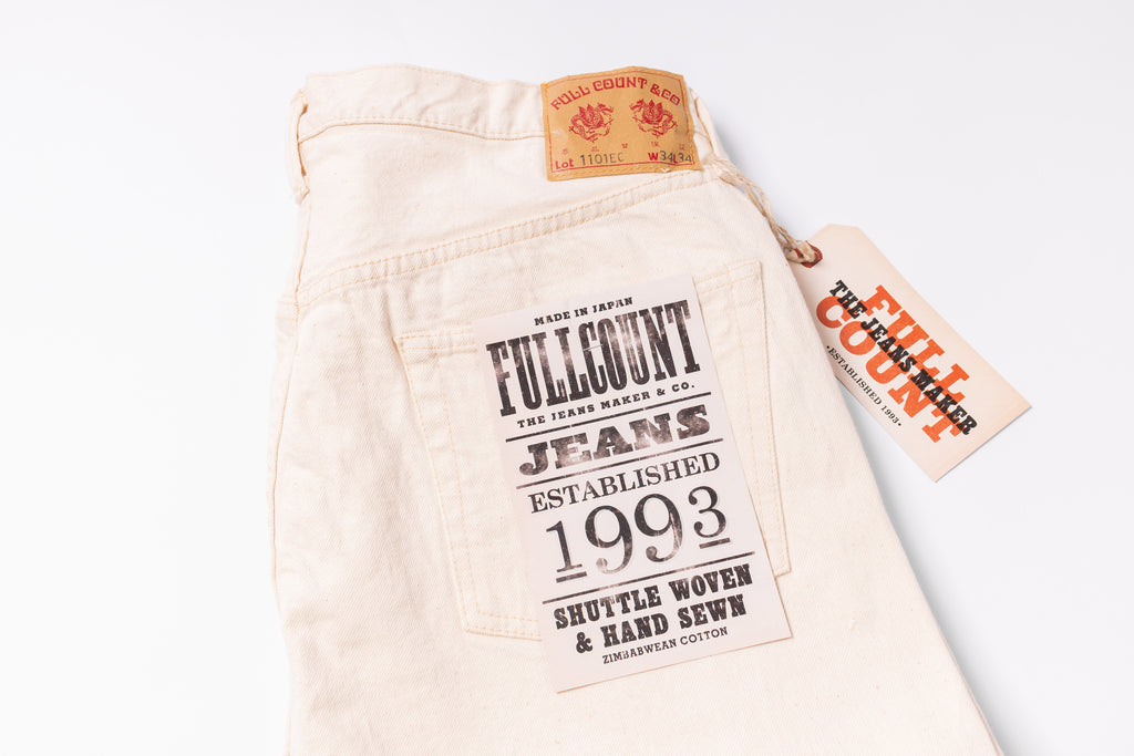 Beige jeans with Fullcount label on a white background