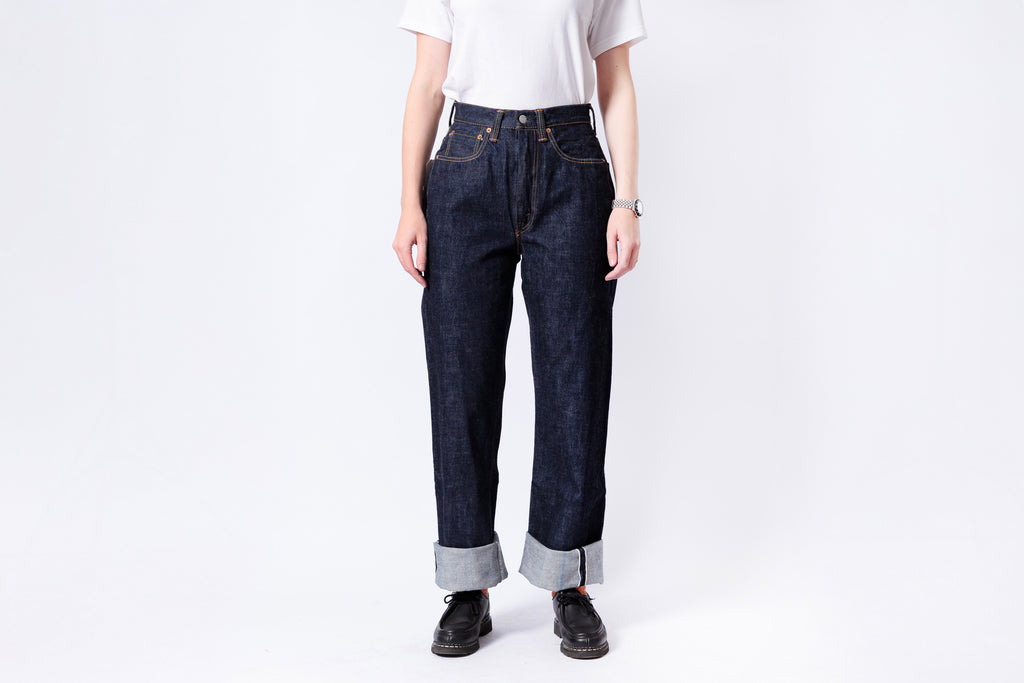 Person wearing dark blue jeans and a white shirt on a white background