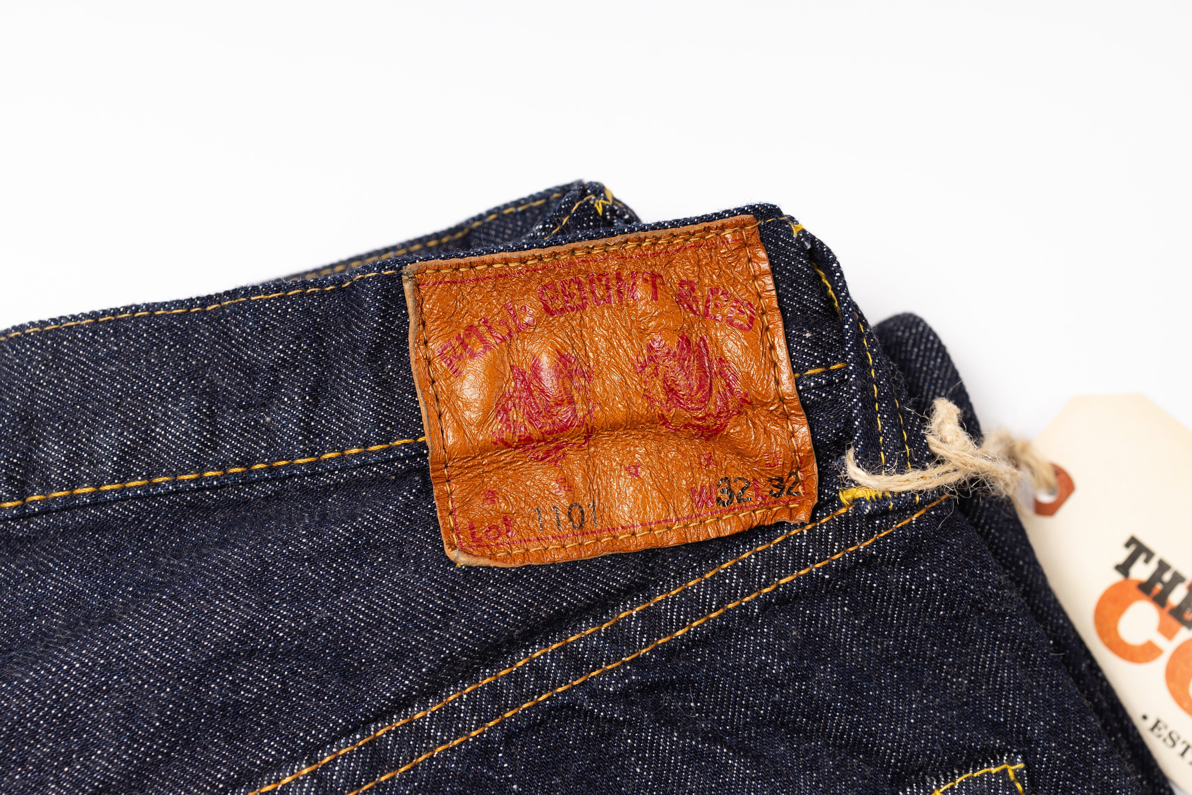 Close-up of a label on a pair of jeans with a white background.