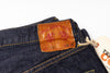 Close-up of a label on a pair of jeans with a white background.