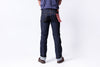 Person wearing dark blue jeans on a white background