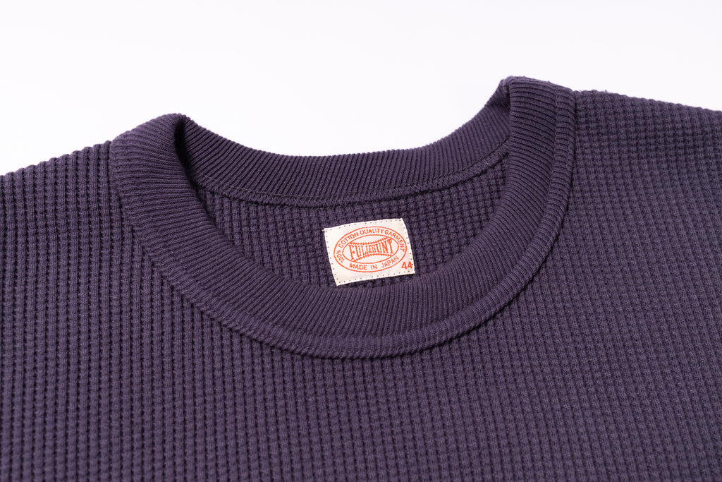 Navy blue textured shirt with a visible brand label on a white background