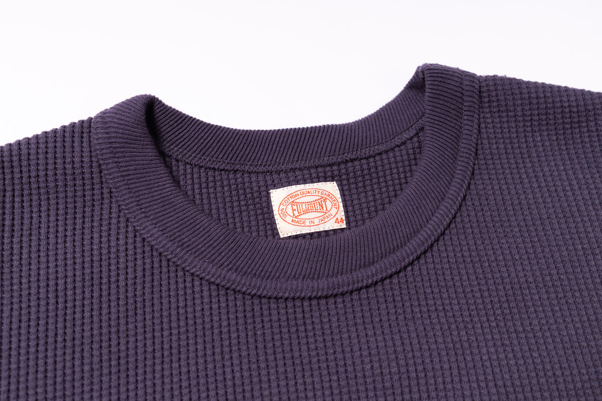 Navy blue textured shirt with a visible brand label on a white background
