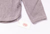 Gray textured pants with a tag on a white background
