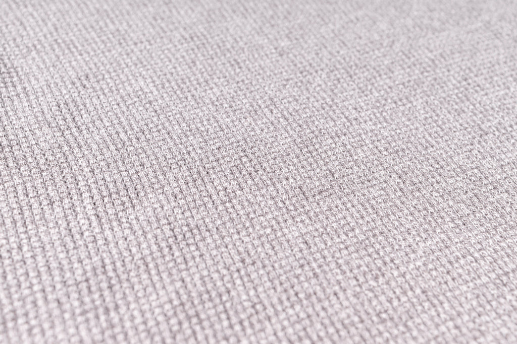 Close-up of a textured light purple fabric surface
