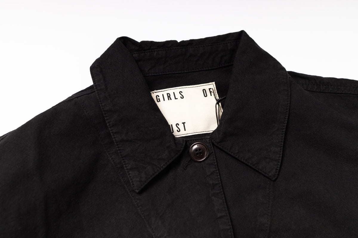 Black jacket with a brand tag on a white background