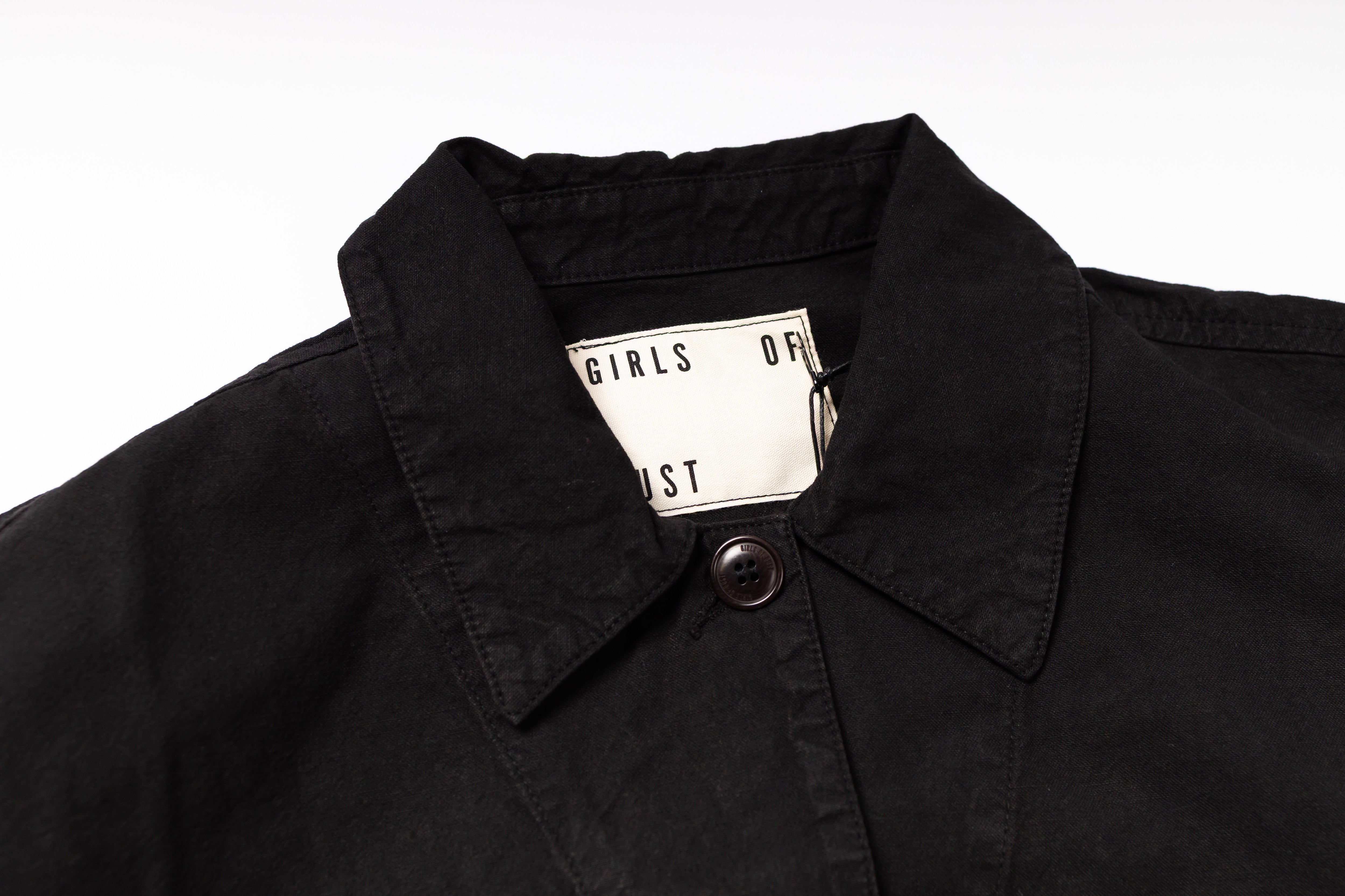 Black jacket with a brand tag on a white background