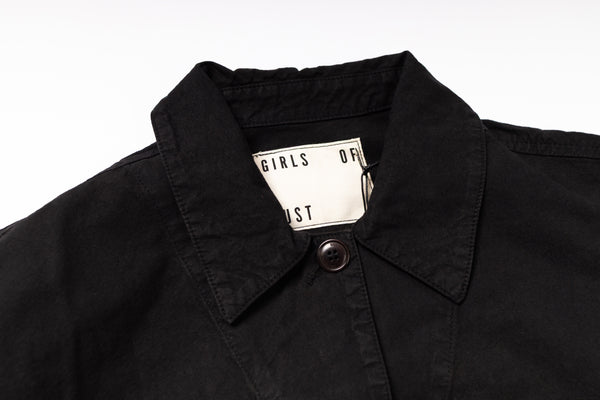Black jacket with a brand tag on a white background