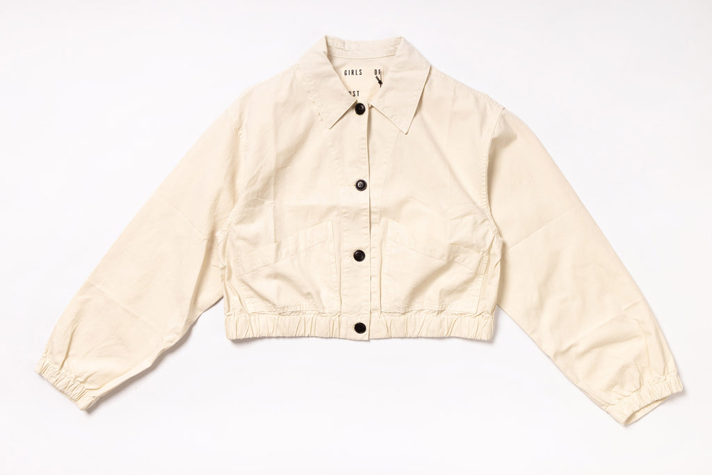 Beige jacket with black buttons on a white background