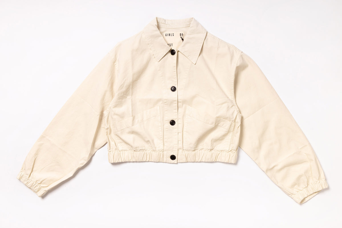 Beige jacket with black buttons on a white background