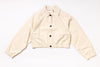 Beige jacket with black buttons on a white background