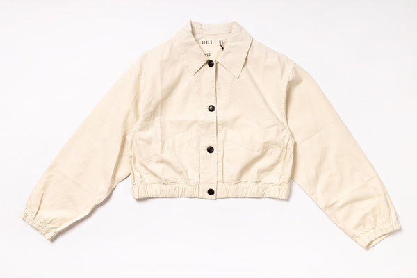 Beige jacket with black buttons on a white background