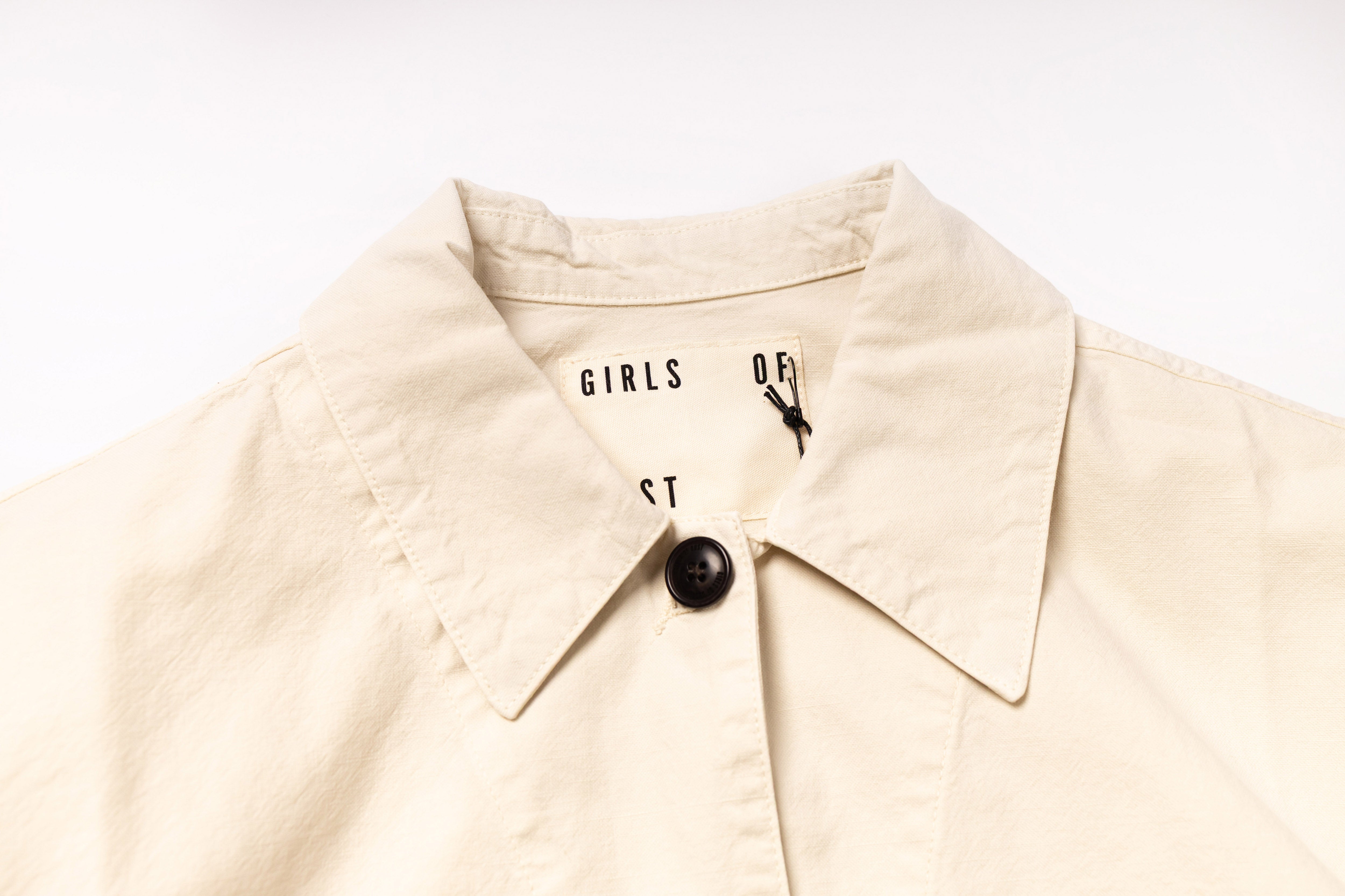Beige jacket with a brand logo on a white background