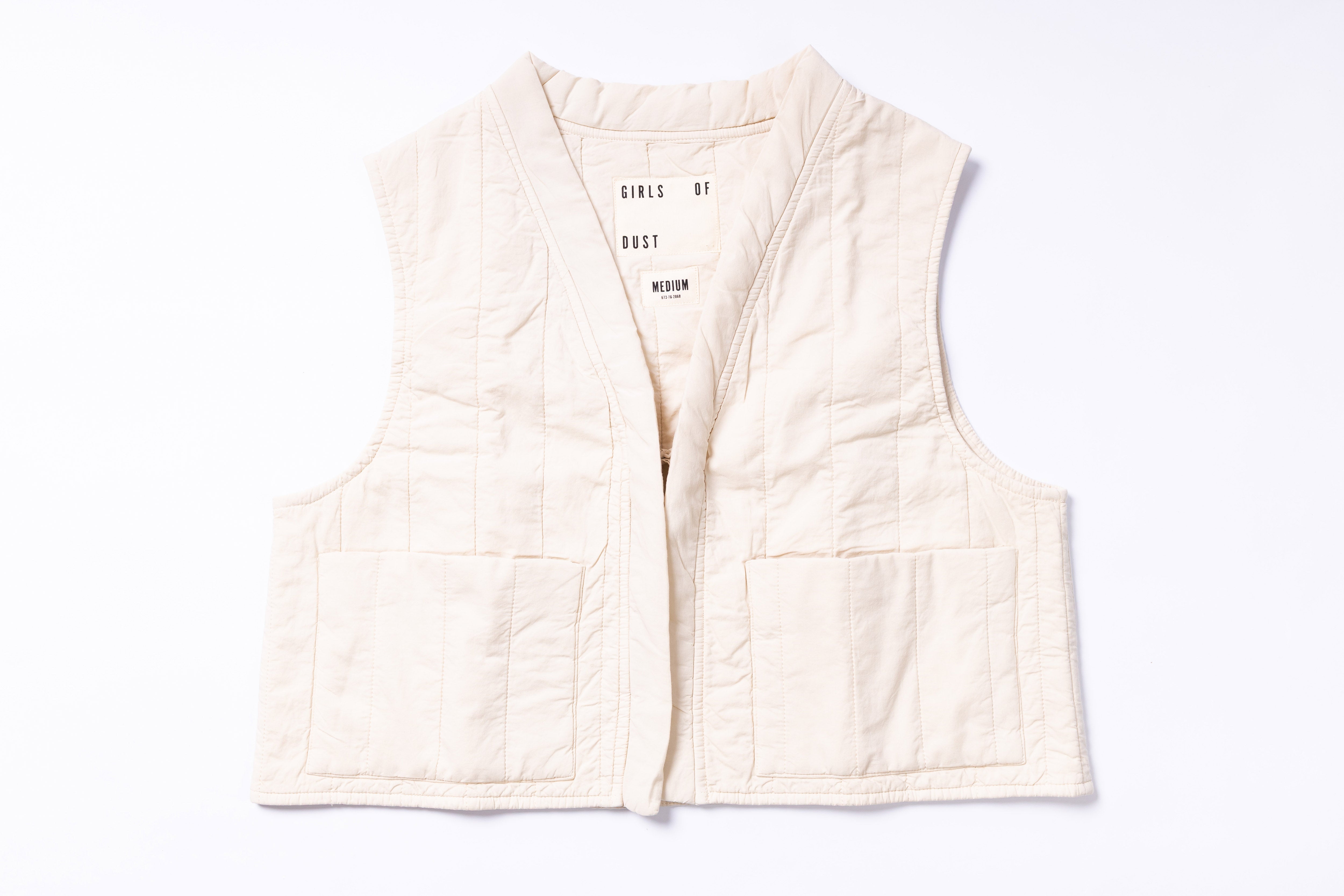 White quilted vest with text on a white background