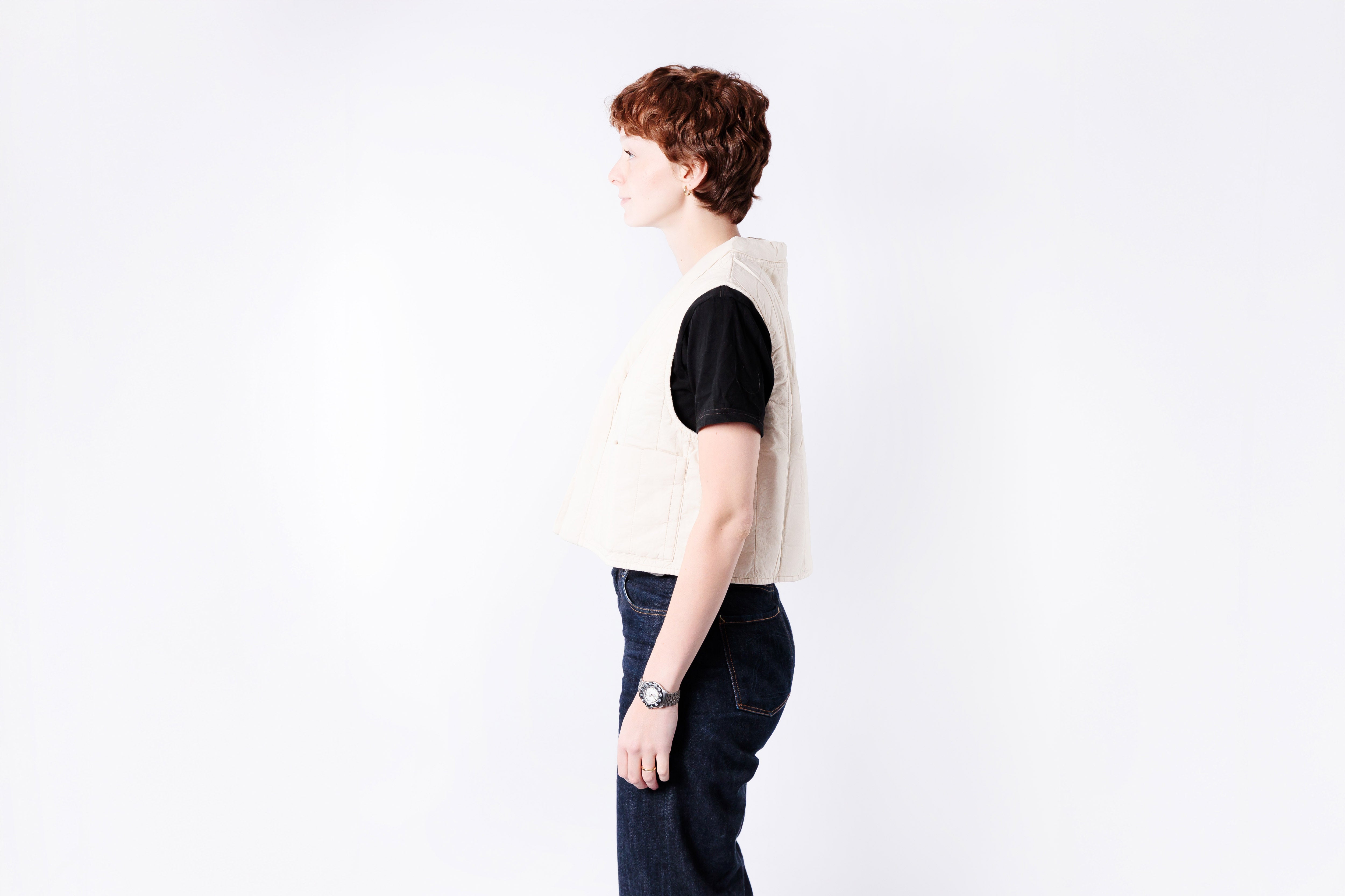 Person wearing a black and white outfit against a white background