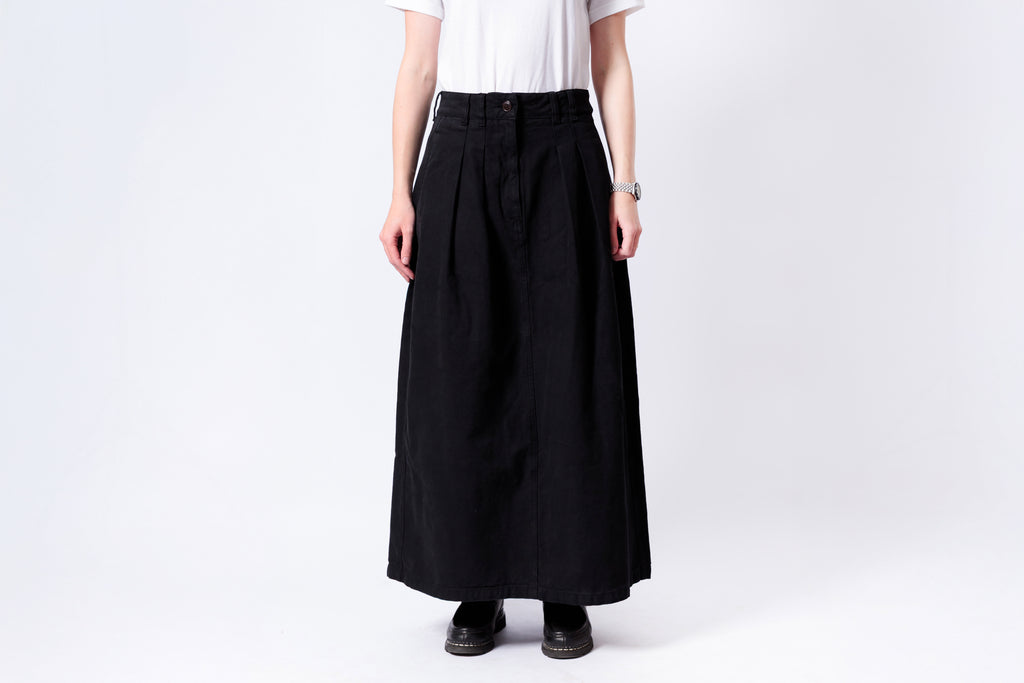 Person wearing a black skirt on a white background