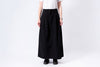 Person wearing a black skirt on a white background