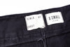 Close-up of black pants with 'GIRLS OF DUST' and 'X-Small' labels.