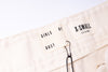 Beige towel with 'Girls of Dust' branding and size label on a white background