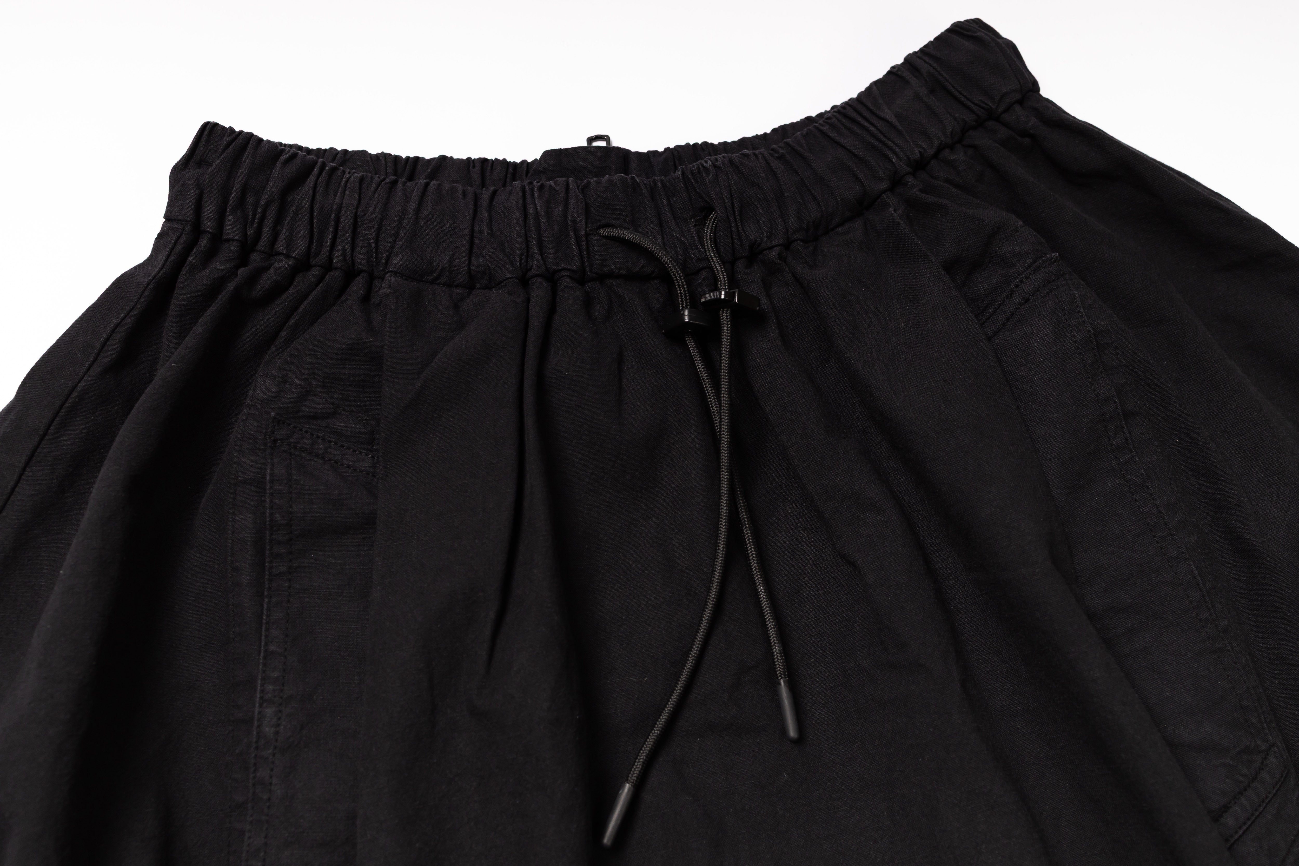 Black pants with drawstring waist on a white background