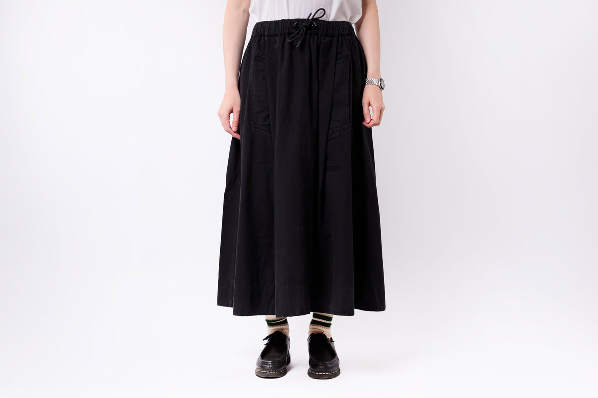 Person wearing a black skirt on a white background