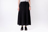 Person wearing a black skirt on a white background