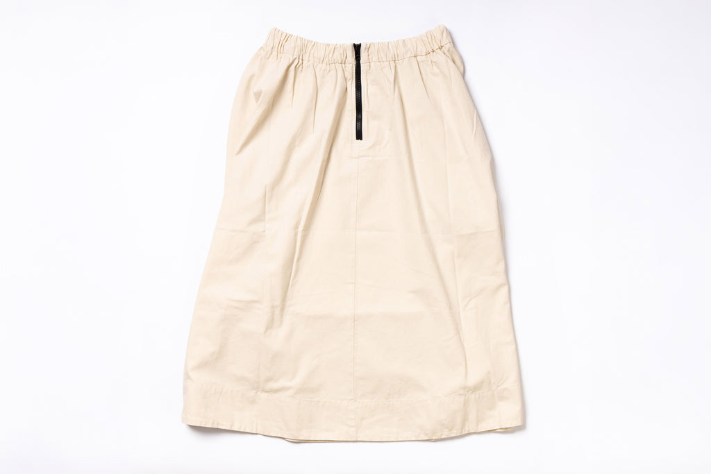 Beige skirt with a black zipper on a white background