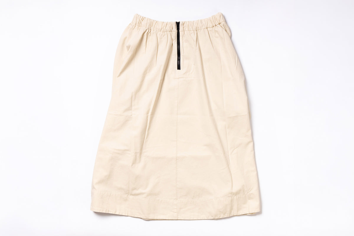 Beige skirt with a black zipper on a white background